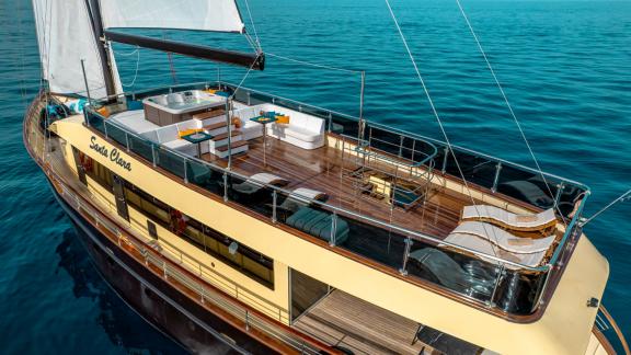 Luxurious upper deck of Santa Clara with a jacuzzi and sun loungers, perfect for relaxation.