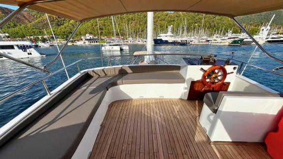 The upper deck of Gulet Ahmet Ertürk features a helm station and comfortable seating areas.