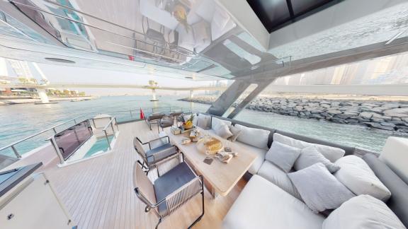 The outdoor seating area of the Ferretti 780 motor yacht makes your hourly yacht rental in Dubai stylish and enjoyable.