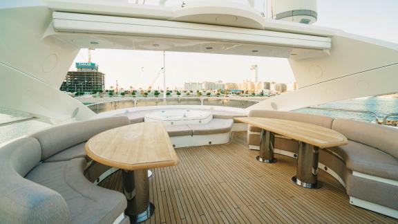 The upper deck of the Lucien motor yacht provides a comfortable social area for luxury yacht rentals in Dubai.