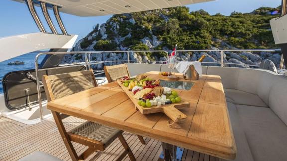 A rich fruit and cheese platter is served on the Sunseeker 75 flybridge with scenic Split in view.