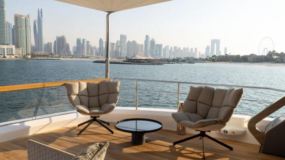 The aft deck of San Lorenzo Sx88 is ideal for hourly yacht rental in Dubai, offering a breathtaking cityscape.