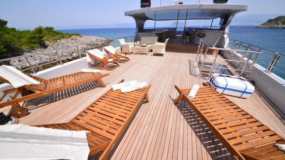 The spacious deck of Simay F yacht with sun loungers and a comfortable seating area is perfect for sunbathing.