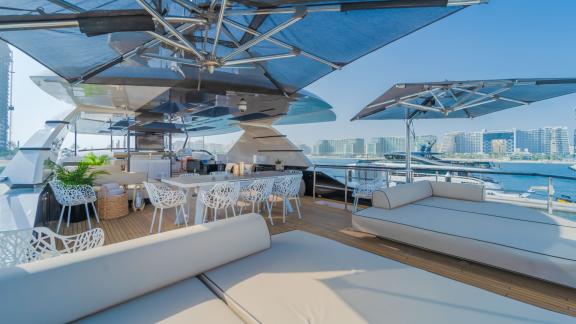 The upper deck of the Saffuriya yacht features stylish sunbathing areas and comfortable seating arrangements.