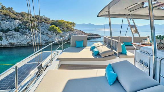 Comfortable loungers with blue cushions offer a perfect spot to enjoy the sea and nature views on Sunmoon’s deck.