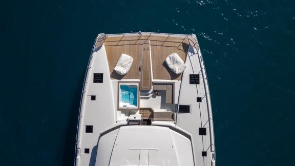 The Power 67 Ariva features a teak foredeck with jacuzzi and loungers while cruising off the coast of Corfu.