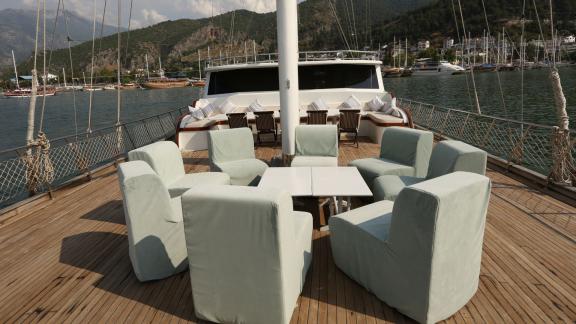 Cosy seating on the deck of the gulet Holiday X with 10 cabins, docked in picturesque Fethiye.