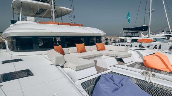Aurelia’s front deck with cushioned seating and colorful pillows.