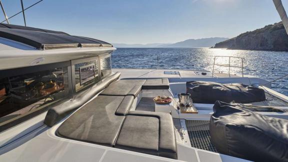 The catamaran Andare Avanti offers bow relaxation with cushions near Athens.
