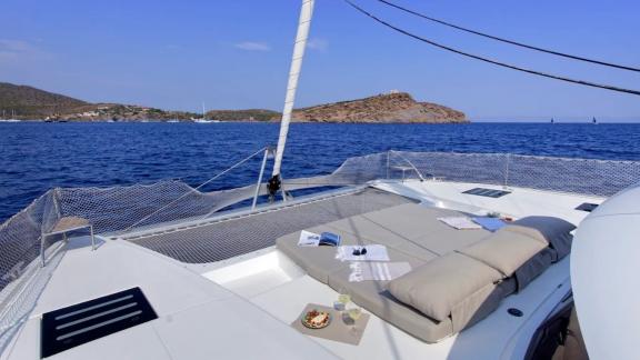 Helidoni charter catamaran offers sunbeds and refreshments on the front deck.