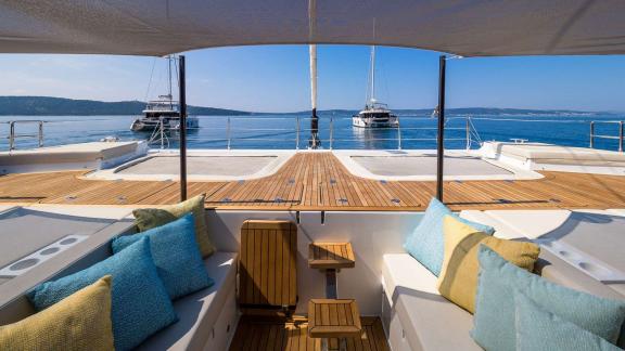 In Kastela Zara’s front deck has shaded seating with colorful pillows and sea view.