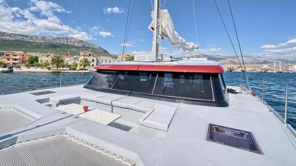 The Red catamaran’s front deck features nets, seating and a scenic view of the coast and mountains.