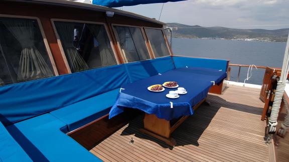 Inviting seating area aboard the Gulet Sunworld 8 with a set table and sea view.