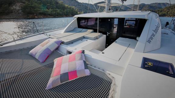 The foredeck of catamaran Derya features soft cushions and a cozy lounging space.