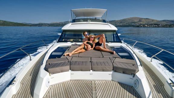 Sunbathers on the foredeck of the motor yacht Simull cruising in Croatia.