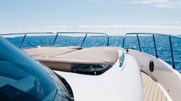 The relaxation area on the front deck of the Orix motor yacht with a sea view.