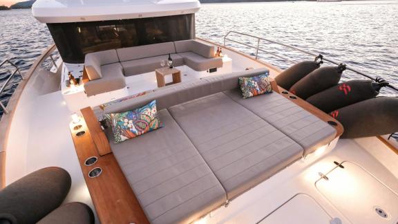 The foredeck of motor yacht La Luna features comfortable seating areas with cozy pillows.