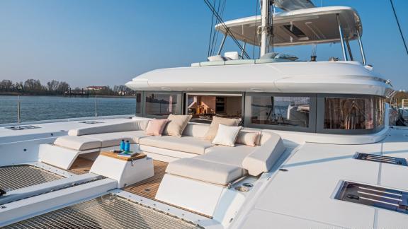 Cozy seating on the Lagoon 55 catamaran overlooking calm waters and a distant shoreline.