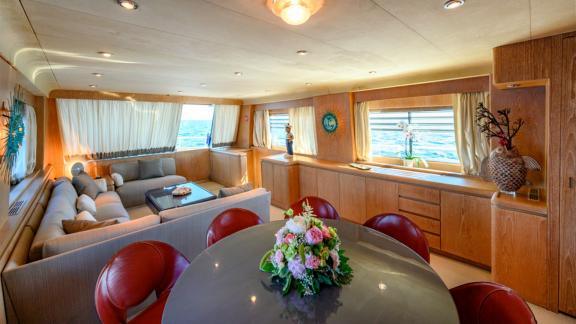 Relax and enjoy delightful meals in the luxurious lounge of Sandi IV with an Italy motor yacht rental.