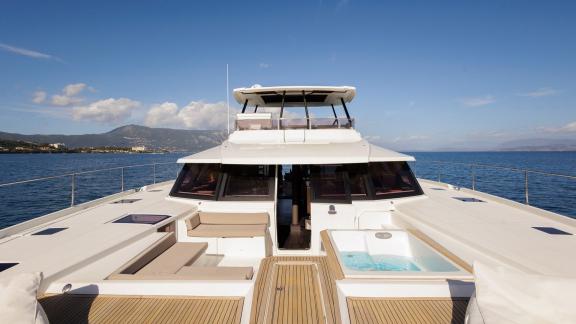 The Power 67 Ariva features a bow jacuzzi, cushioned benches and panoramic sea views while cruising Corfu.