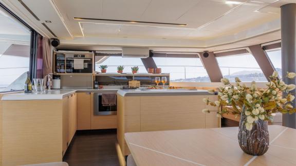The Ariva Power 67 has a full kitchen in the salon with large windows and sea views.