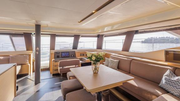 The Power 67 Ariva features a spacious salon with wraparound windows, dining area, and stunning Corfu scenery.