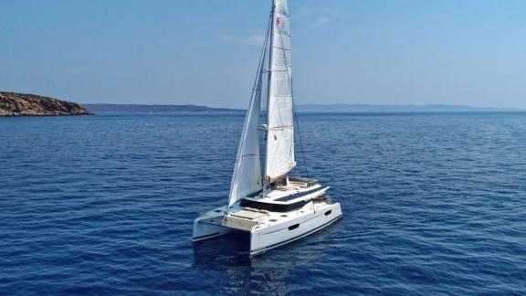 Helidoni charter catamaran cruises peacefully on Aegean waters near Volos.