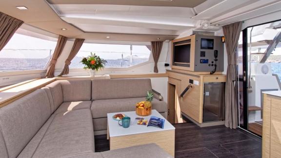 Helidoni charter catamaran features a bright lounge with sea views and soft seating.