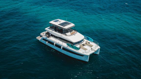 Among Lefkada catamaran rental options Premium shows wide deck and twin hull structure cruising at sea.