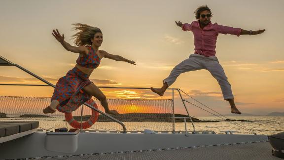 Jumping into sunset fun on a catamaran day tour from Alimos Marina in Athens.