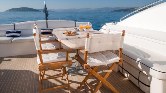 On the Glorious motor yacht, an elegant table with a sea view is set for breakfast.