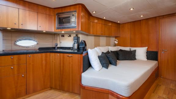 The kitchen and cozy lounging area of the Glorious motor yacht.