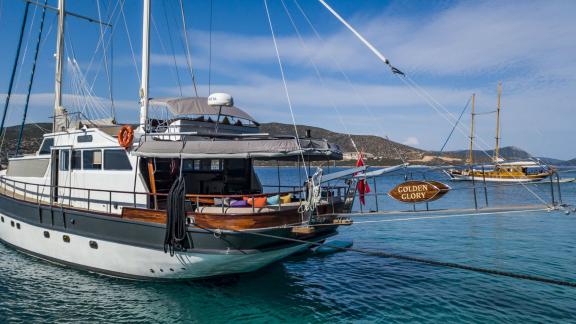 The Gulet Golden Glory anchored off the scenic coast of Bodrum, ready for your next charter adventure.