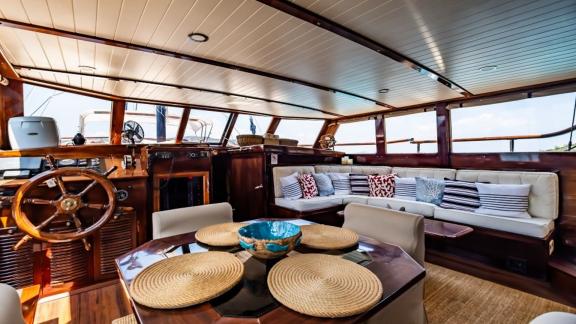 Tastefully decorated interior with lounge area and helm station on Gulet Golden Joy in Bodrum.