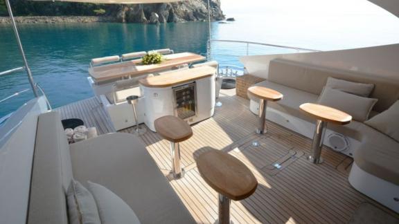 Comfortable seating area and dining table on a motor yacht with a sea view.