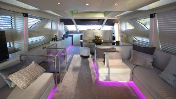 Luxurious and stylish salon area of a motor yacht with modern lighting.