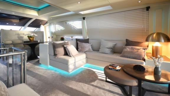 Stylish and comfortable salon of a motor yacht with subtle lighting.