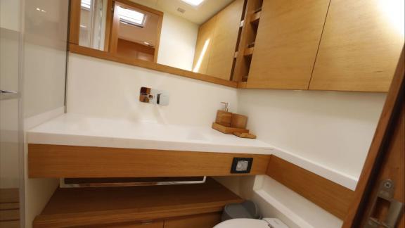 Modern bathroom of the Grand Soleil 58 Morfely sailing yacht in Sardinia, Italy. Complementing onboard comfort.