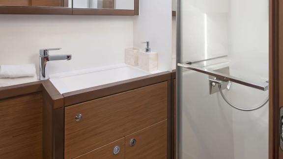 The modern bathroom of the Lagoon 560 in Athens features a stylish vanity and shower combination with elegant finishes.