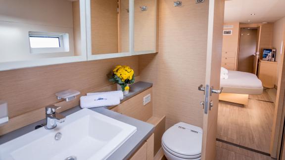 Stylish bathroom on a catamaran, equipped with modern sanitary fixtures, with direct access to the comfortable cabin.