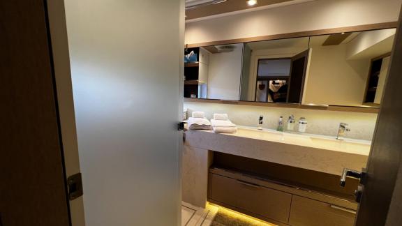 Modern bathroom with a wide vanity and large mirrors, offering plenty of space and comfort.