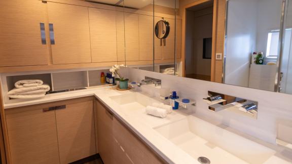 Modern bathroom on the Serenissima catamaran with double sinks and ample storage space.