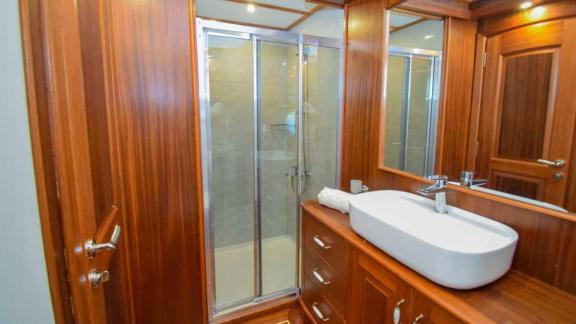 Stylish bathroom with shower and elegant wood paneling on the Gulet Baba Can.