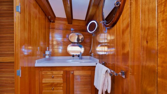 A stylish bathroom on board the Flas VII with wooden panelling and a modern wash area.