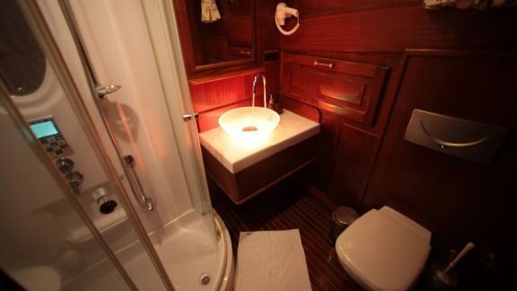 Stylish bathroom of the Gulet Doris with a shower cabin and elegant lighting.