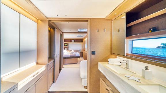 Modern bathroom with sink, overlooking the adjoining cabin with large windows and stylish details