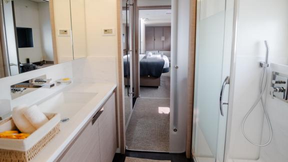 Modern bathroom with shower and view of a comfortable cabin on a catamaran.