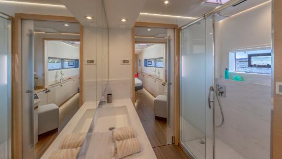 Elegant bathroom with large shower and sea view on the Serenissima catamaran.