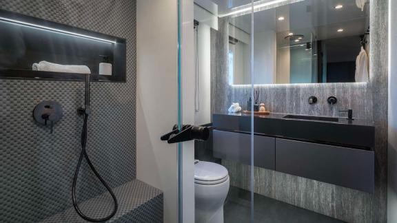 Modern bathroom on the Catamaran Alteya featuring a glass shower, stylish sink, and high-quality fittings.