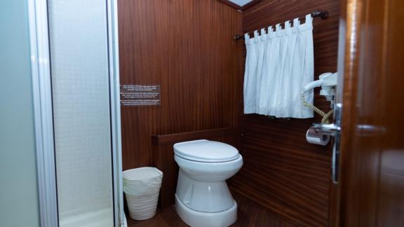 Modern bathroom with toilet and shower cabin on Yacht Kanarya.